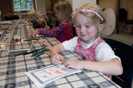 Girl drawing at the Norwegian Postal Museum at Maihaugen in Lillehammer in Norway.